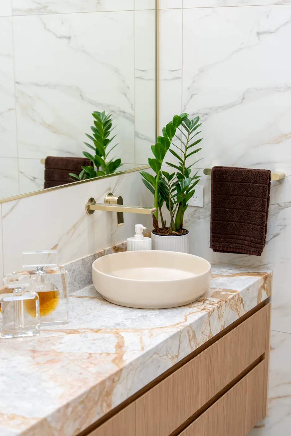 Stone vessel basin with brushed brass tapware and styling