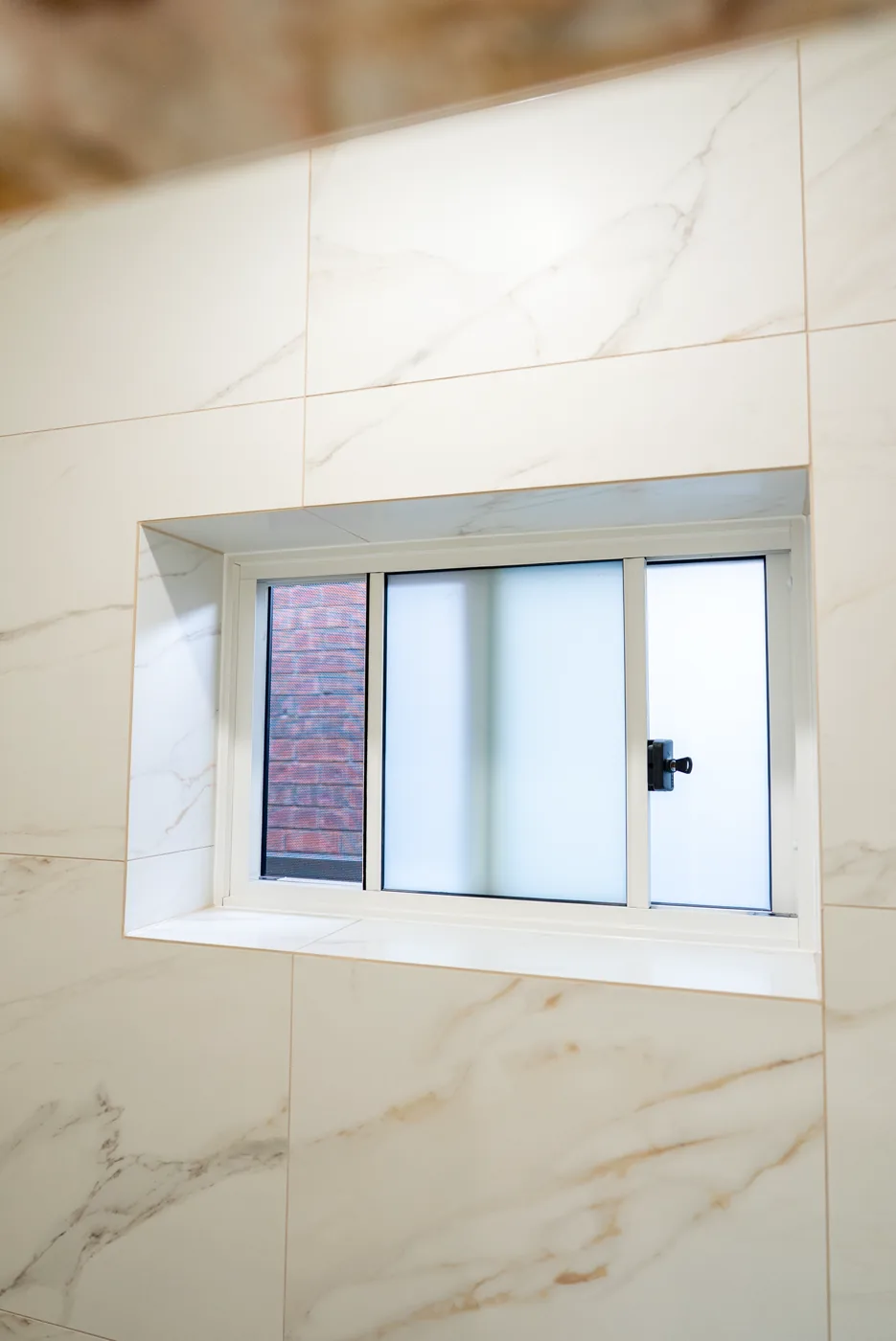 Marble-framed picture window in a premium bathroom