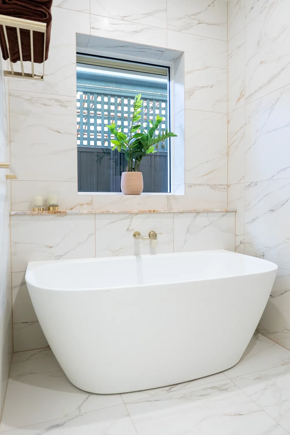 Completed premium bathroom with freestanding stone bath and marble tiling by Package Deal Bathrooms